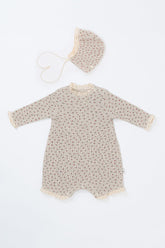 Front view of the Lumiere Bodysuit in Mellow Rose – featuring delicate lace trim and a subtle rose print for babies.